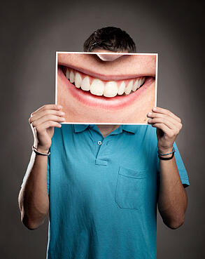 451629737_Young_man_holding_a_smile